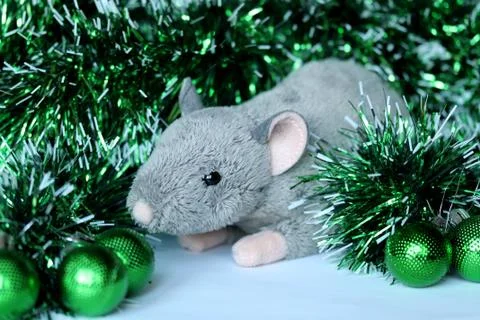 Cute rat or mouse soft toy with green ornaments and tinsel Stock Photos