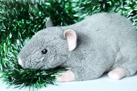 Cute rat or mouse soft toy with green tinsel Stock Photos