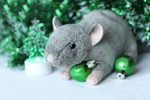 Cute rat or mouse soft toy with green ornaments and tinsel Stock Photos