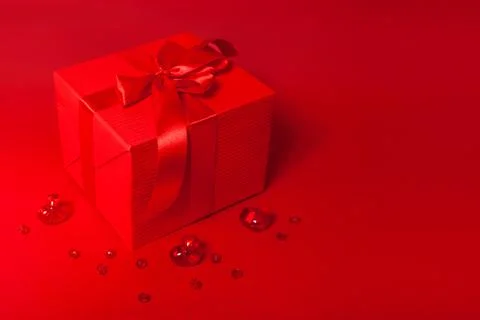Cute red gift box on the red background Stock Photos