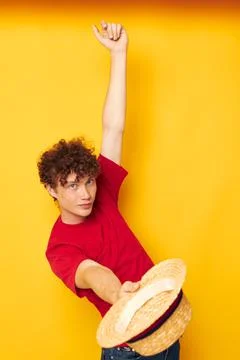 Cute red-haired guy emotions red t-shirt hat studio yellow background unaltered Stock Photos