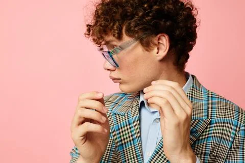 Cute red-haired guy folder for papers blank sheet posing in suit pink background Stock Photos