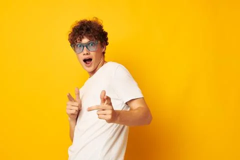 Cute red-haired guy in a white t-shirt blue fashion glasses isolated background Stock Photos