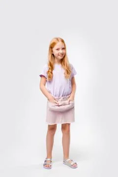 Cute red-haired long-haired girl in daily clothes Stock Photos