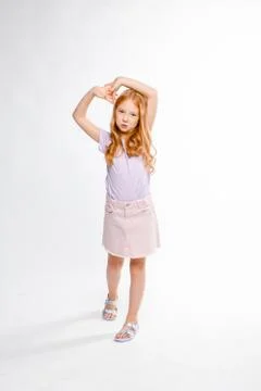 Cute red-haired long-haired girl in daily clothes dancing Stock Photos