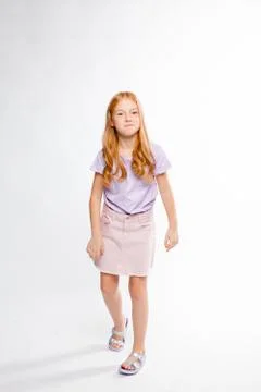 Cute red-haired long-haired girl in daily clothes dancing Stock Photos