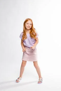 Cute red-haired long-haired girl in daily clothes dancing Stock Photos