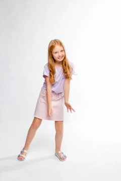 Cute red-haired long-haired girl in daily clothes dancing Foto stock