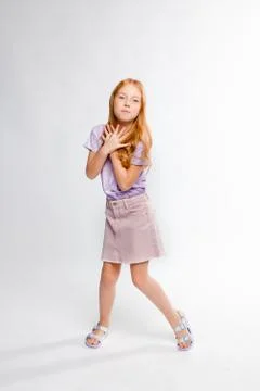 Cute red-haired long-haired girl in daily clothes dancing Stock Photos