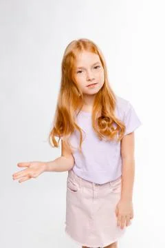 Cute red-haired long-haired girl in daily clothes Stock Photos