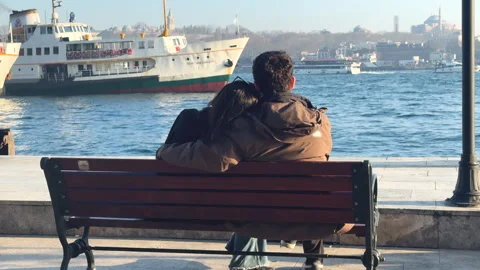 Cute romantic couple sits bench embracing, hug by waterfront. Stock Footage 307011839