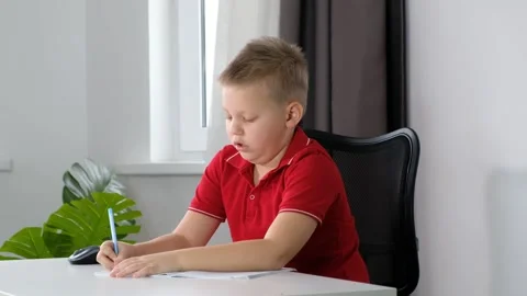 Cute school boy child doing his homework at home and feeling tired, sleepy and Stock Footage 171622619