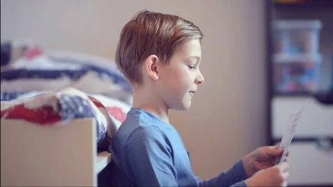 Cute school boy learning his homework in room Stock Footage 72251068