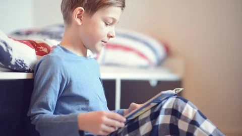 Cute school boy learning his homework in room Stock Footage 72574057
