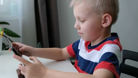 Cute school boy learning or playing on computer tablet pc, distance education Stock Footage 170002089
