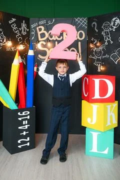 Cute schoolboy holding the number two Stock Photos