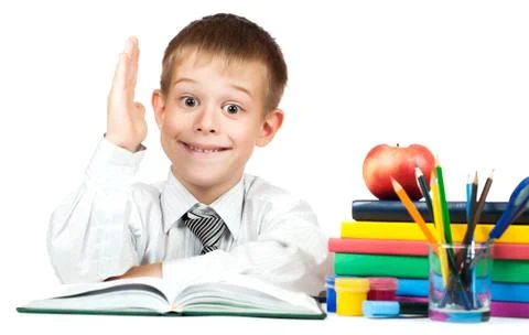 Cute schoolboy is pulling his hand to answer. isolated Stock Photos