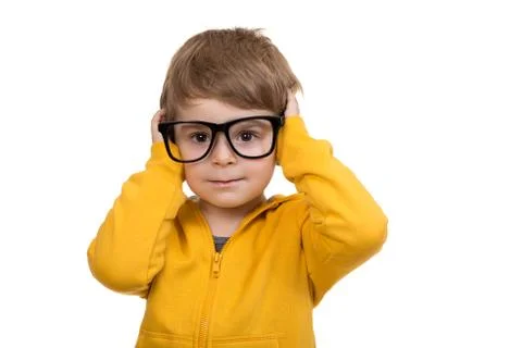 Cute schoolboy thinking idea while wearing glasses and looking at up, isolated Foto stock