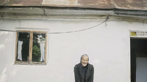Cute senior woman standing in front of home Stock Footage