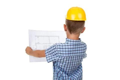 Cute serious builder boy is reading a building paper plan, turned back, isolated Stock Photos