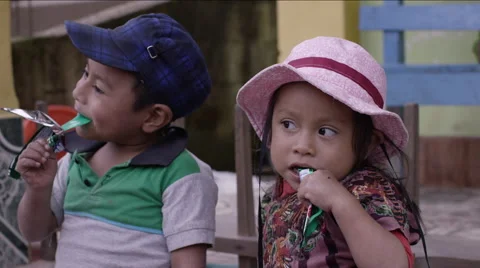 Cute siblings having chocolate together, Guatemala Stock Footage 63054879