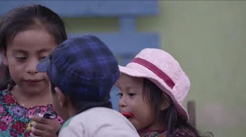 Cute siblings sharing their chocolates, Guatemala Stock Footage 63054685