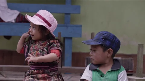 Cute siblings sitting side by side, Guatemala Stock Footage 63054458