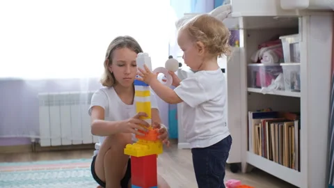 Cute sisters happily stacking blocks together Vídeo Stock 283293742