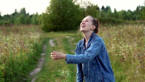 Cute slender red-haired girl flies a kite in the sky Stock Footage 201602910