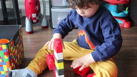 Cute small boy making lego shapes Stock Footage 132825222