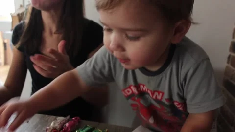 Cute small boy is playing with sweets Stock Footage 123072944