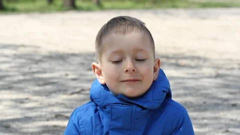 Cute small boy something is telling on camera and making funny faces. Stock Footage 106807805
