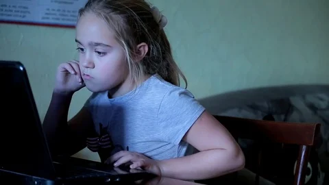 Cute small girl working at the computer. Dependence on gadgets Stock Footage 82730921