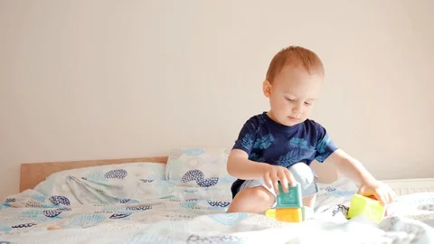Cute small toddler doing brain exercises. Baby boy playing development  Stock Footage 128945768