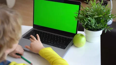 Cute smart caucasian primary School Child typing on the keyboard laptop. Online Stock Footage 234653840