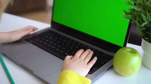Cute smart caucasian primary School Child typing on the keyboard laptop. Online Stock Footage 234653899
