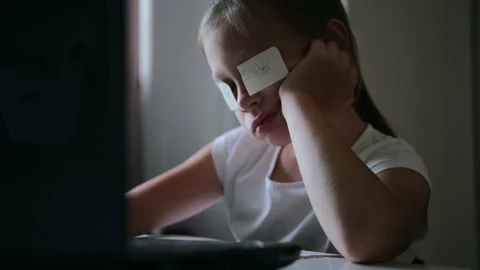 Cute smart elementary school child girl doing math homework sits at home behind Video stock 134714161