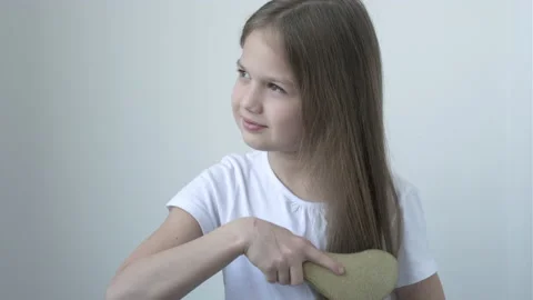 Cute smiling 9 years old girl brushing her long hair Video stock 170688194