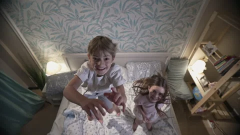 Cute smiling children having fun in bedroom. Stock Footage 164942150