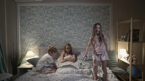 Cute smiling children having fun in bedroom. Stock Footage 164942618