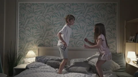 Cute smiling children having fun in bedroom. Stock Footage 164987244