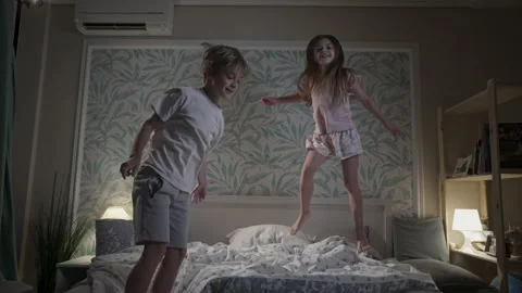 Cute smiling children having fun in bedroom. Stock Footage 165530258