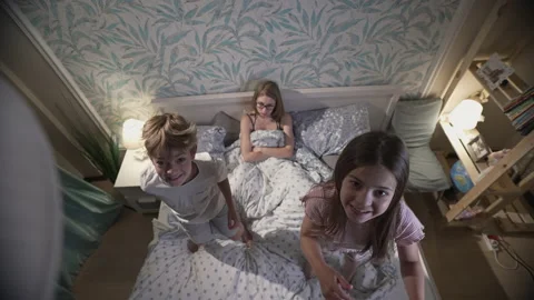 Cute smiling children having fun in bedroom. Stock Footage 165532707