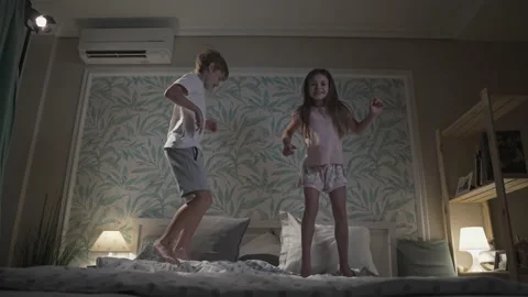 Cute smiling children having fun in bedroom. Stock Footage 165619011