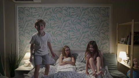 Cute smiling children having fun in bedroom. Stock Footage 165986737