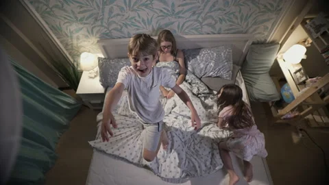 Cute smiling children having fun in bedroom. Stock Footage 165988571
