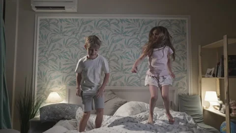 Cute smiling children having fun in bedroom. Stock Footage 166026111