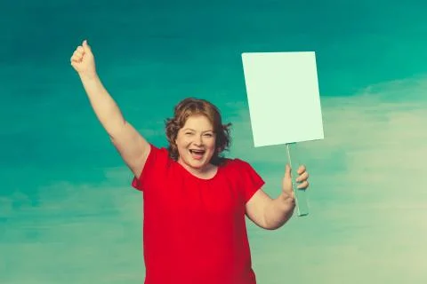 Cute smiling chubby red-haired woman screaming fervently, waving his hand in  Stock Photos