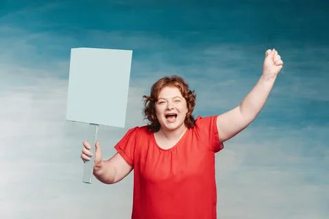 Cute smiling chubby red-haired woman screaming fervently, waving his hand in  Stock Photos
