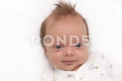Cute Smiling newborn baby boy. Adorable infant looking at camera. Stock Photos